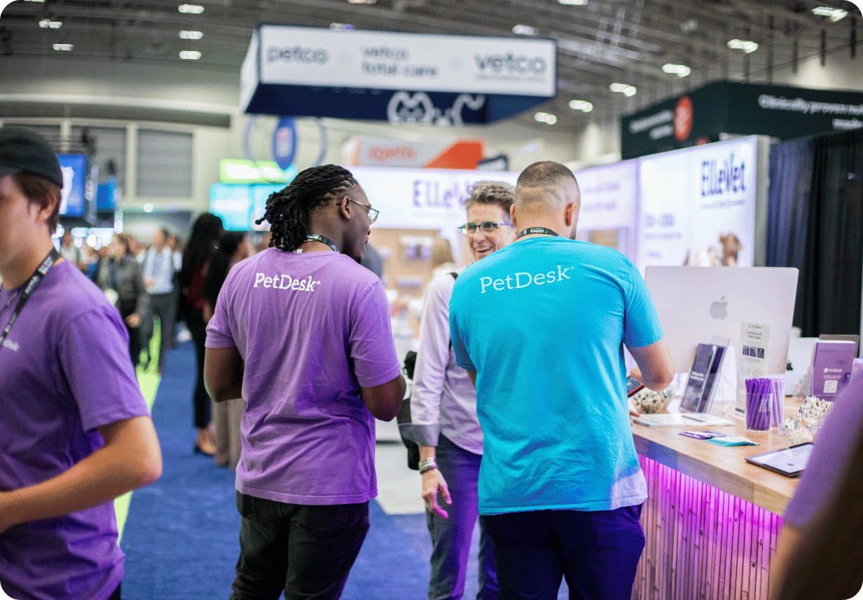 Two PetDesk Employee's Happily Chatting with a Prospective Customer